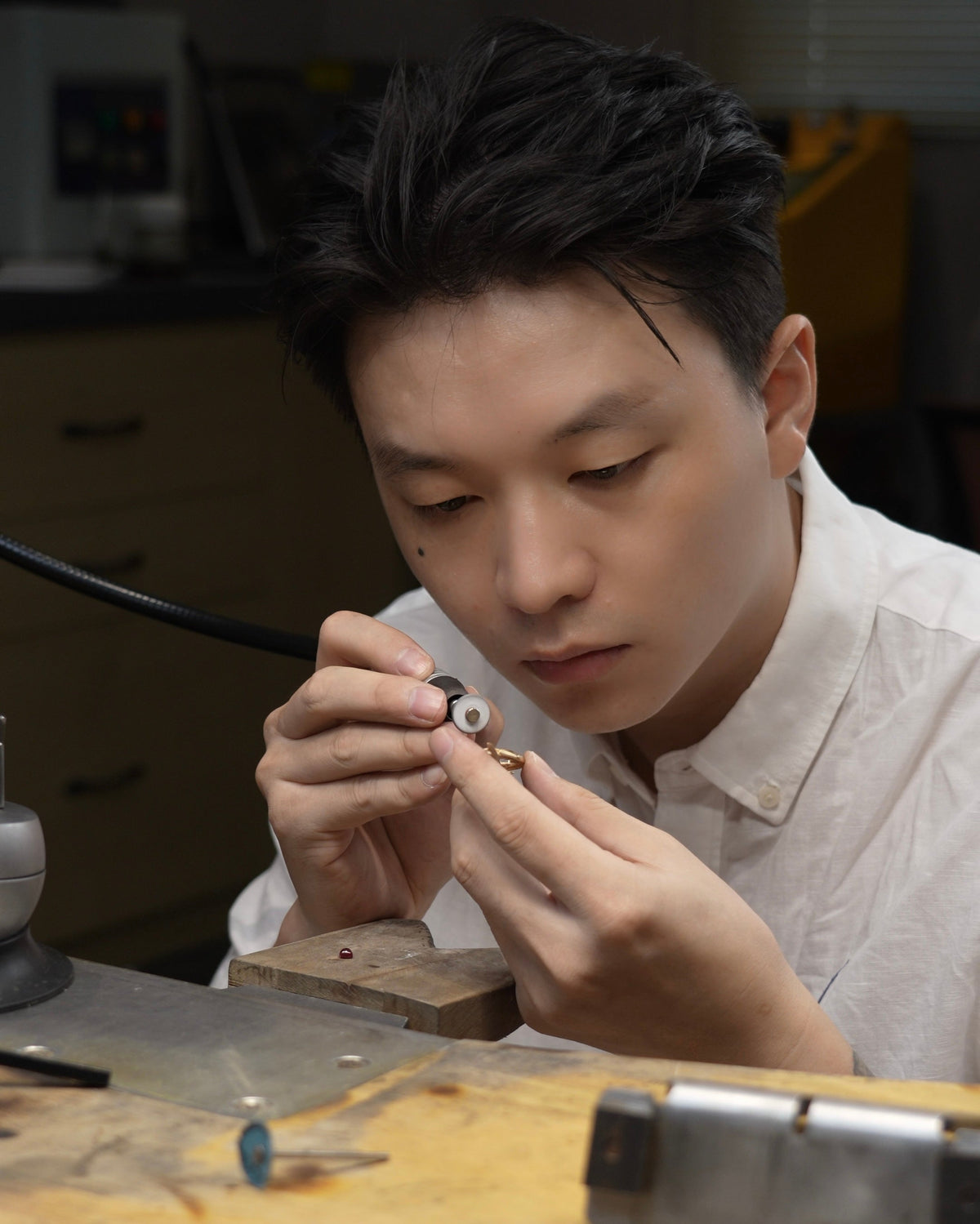 Lin working on a gold ring at the jewelry bench.