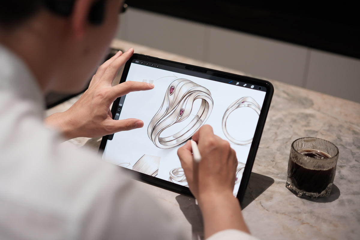 Lin developing a ring design on a tablet in the studio.